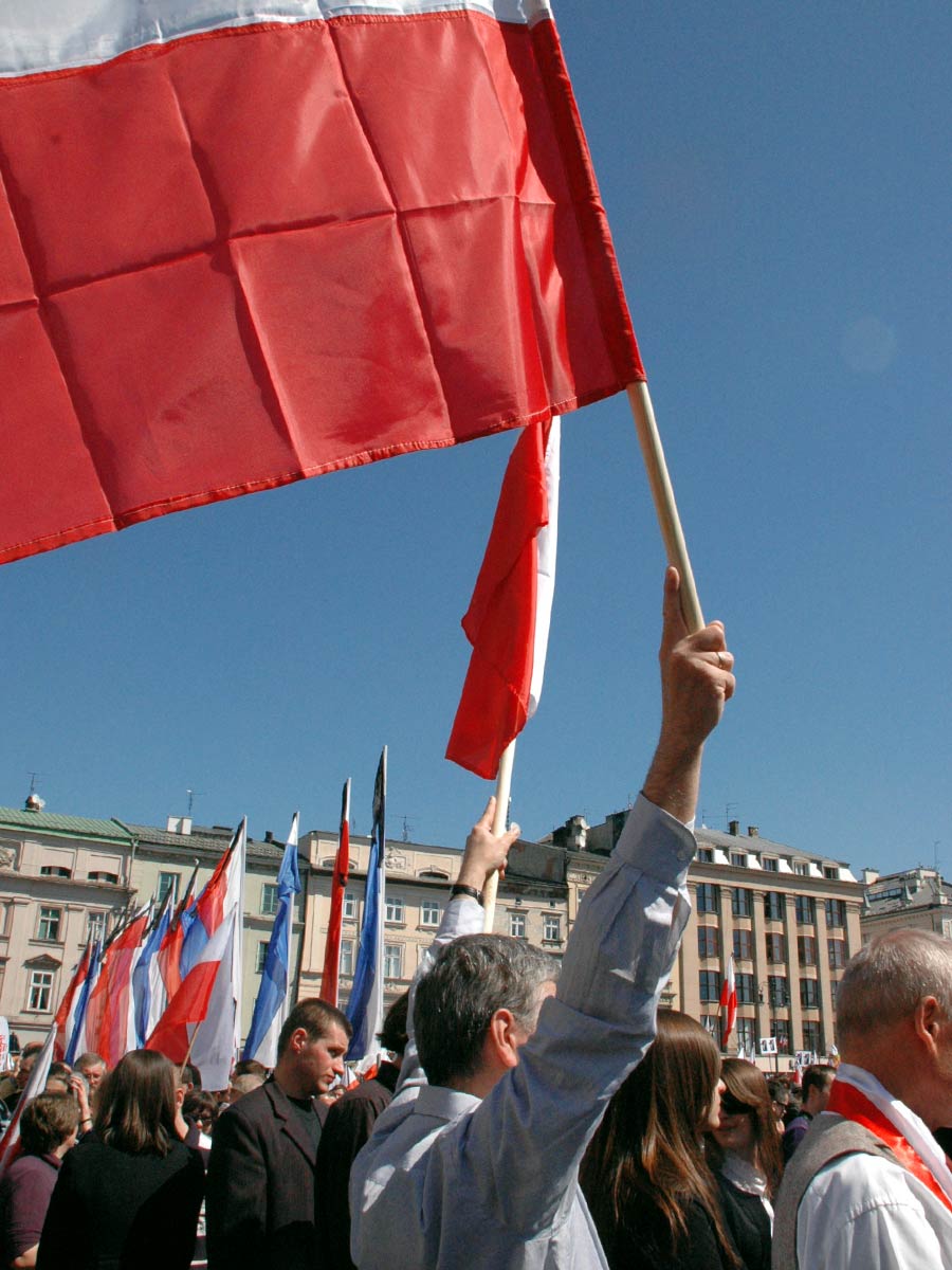 man with polish flag at smolensk funeral krakow the food quest