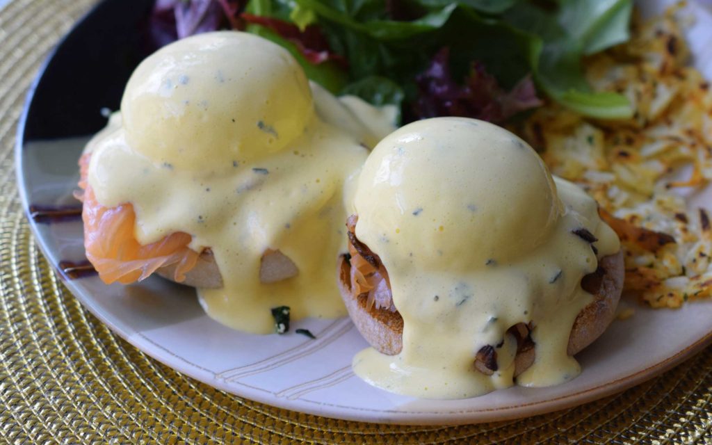 Smoked salmon eggs benedict drenched in hollandaise