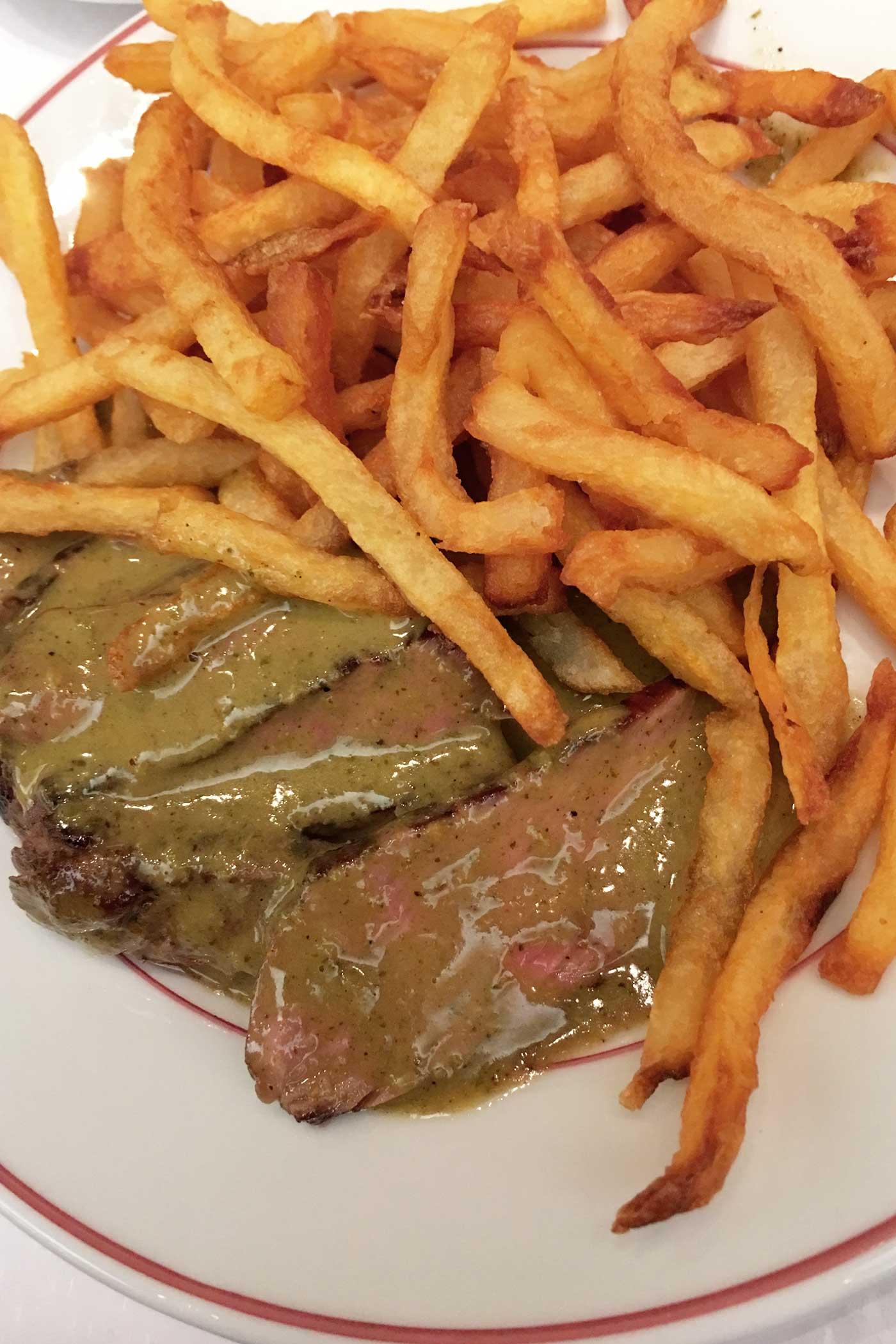 best steak frites with mustard sauce at Relais de l’Entrecôte in paris the food quest